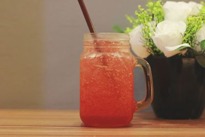 Close-up of drink in glass jar on table