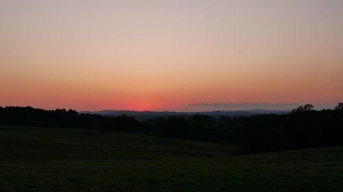 Scenic view of silhouette landscape against sky during sunset