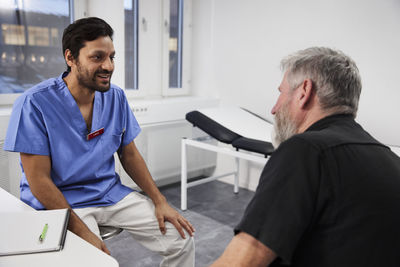 Male doctor talking to senior patient during appointment
