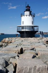 View of lighthouse on beach against sky