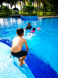 Family swimming in pool