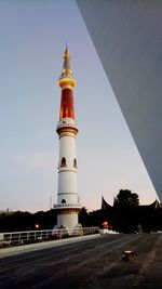 View of lighthouse against buildings in city