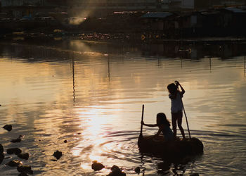 Rear view of man standing in lake