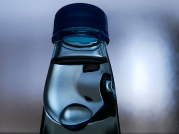 Close-up of water bottle against blue background