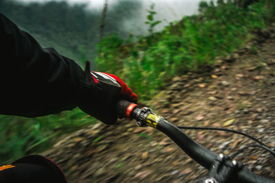 Cropped image of person cycling on mountain