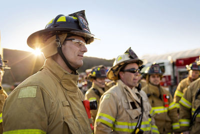 Firefighters standing at fire station