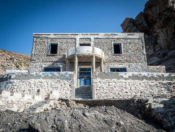 Low angle view of old building against blue sky