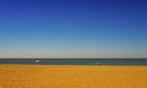 Scenic view of sea against clear blue sky