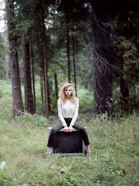 Portrait of woman sitting in forest