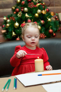 Cute 3x girl playing on the table christmas tree.
