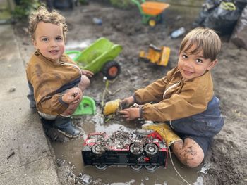 High angle view of boy playing with toy car