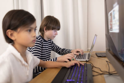 Boys using computers at home