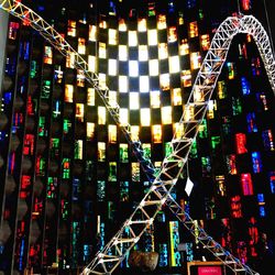 Low angle view of illuminated ferris wheel against sky