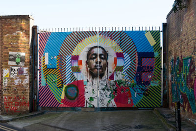 Portrait of man with graffiti on wall