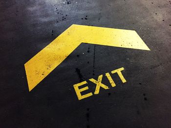 Close-up of arrow sign on road