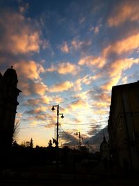 Low angle view of silhouette buildings against sky