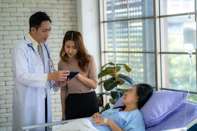 Portrait of female doctor using digital tablet