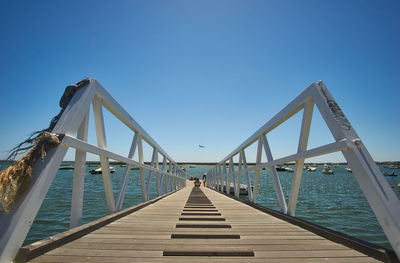 View of pier against clear blue sky