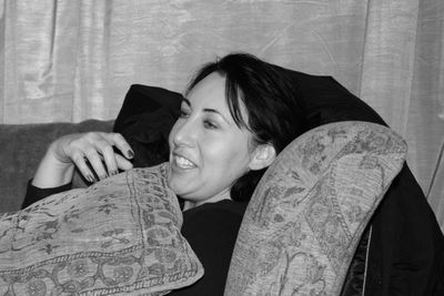 Close-up of woman on sofa at home