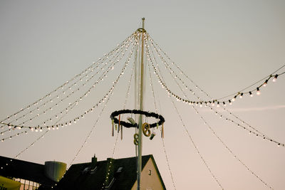 Low angle view of fairy lights against clear sky