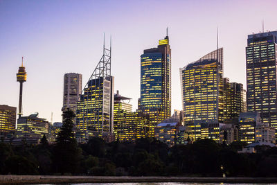 Buildings in city against clear sky