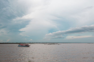 Scenic view of sea against cloudy sky