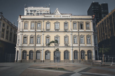 Facade of old building in city against sky