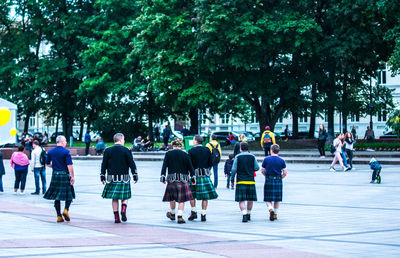 Rear view of people walking on street