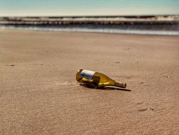 Glass bottle on sand at beach