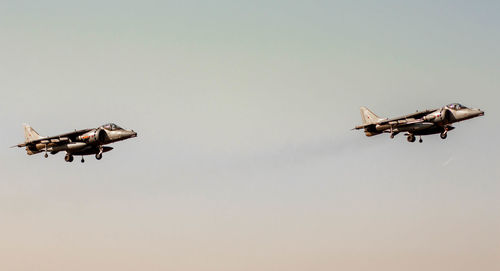 Low angle view of airplane flying against clear sky