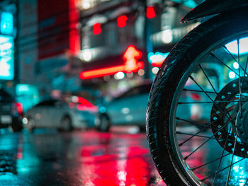 Close-up of wet bicycle on road in city