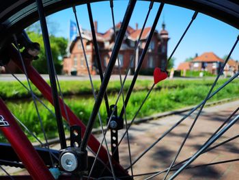 Close-up of bicycle on field seen through window