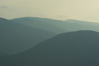 A landscape with foggy mountains silhouettes at morning sunrise. crimean peninsula, sidam qaya