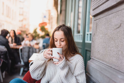 Young woman using mobile phone outdoors