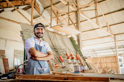 Portrait of young man standing against building