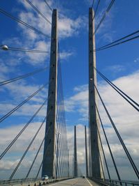 Low angle view of suspension bridge against sky