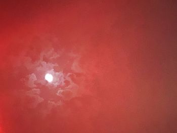 Low angle view of illuminated moon against sky at night