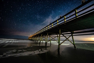 Scenic view of beach against sky at night