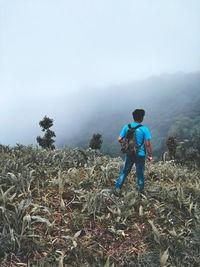 Full length of friends on mountain against sky