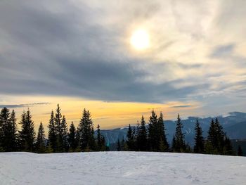 Scenic view of snowcapped landscape against sky during sunset