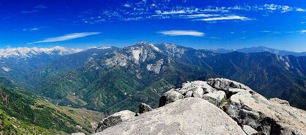 Scenic view of rocky mountains against blue sky