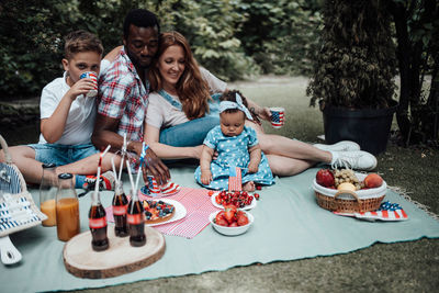 Rear view of people sitting on table