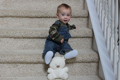 Portrait of cute baby boy on staircase