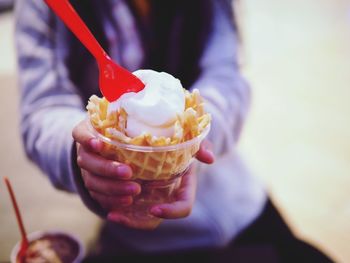 Cropped image of person holding ice cream