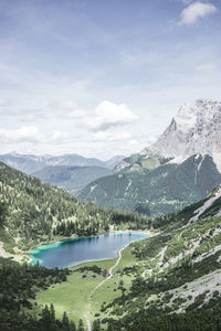 Scenic view of calm lake against mountain range