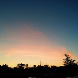 Silhouette of trees against sky at sunset