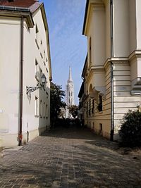 Street amidst buildings against sky