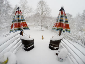 Traditional windmill in winter against sky