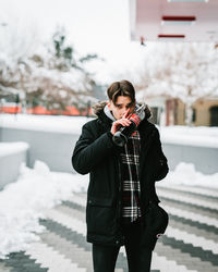 Full length of teenage girl standing on snow