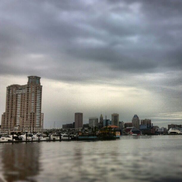 water, waterfront, building exterior, city, architecture, sky, built structure, cloud - sky, sea, cityscape, skyscraper, cloudy, river, urban skyline, cloud, office building, modern, weather, dusk, overcast